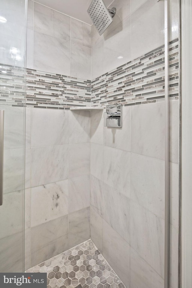 bathroom with a tile shower