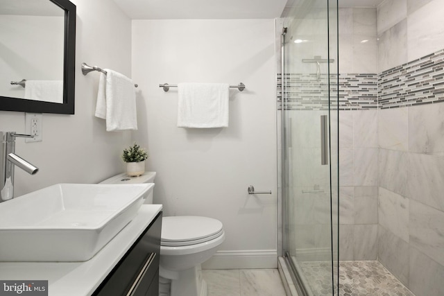 bathroom with vanity, toilet, and an enclosed shower