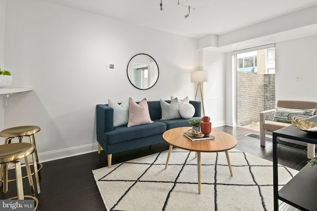 living room with wood-type flooring and track lighting