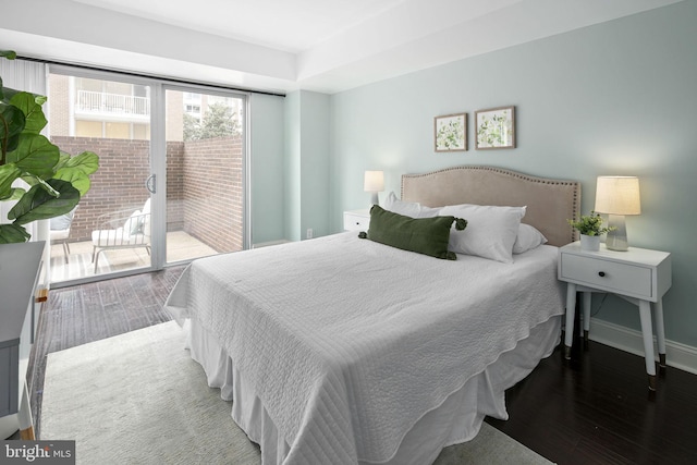 bedroom with access to outside and hardwood / wood-style floors