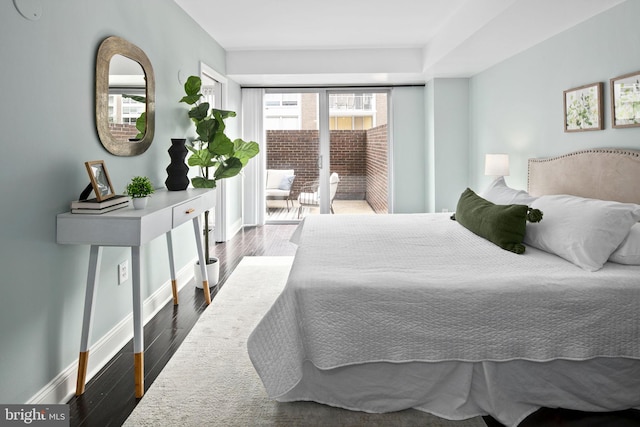 bedroom featuring access to outside and dark hardwood / wood-style flooring