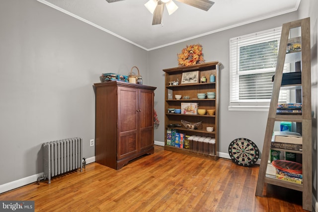 miscellaneous room with ceiling fan, radiator, hardwood / wood-style flooring, and crown molding