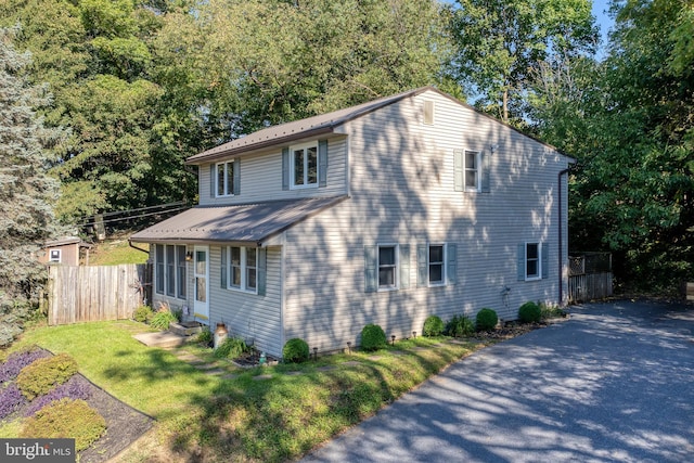 view of side of home with a lawn