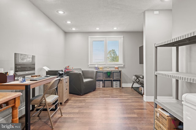 home office featuring a textured ceiling and hardwood / wood-style floors