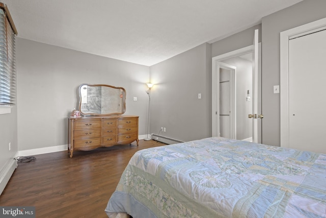 bedroom with dark hardwood / wood-style floors and baseboard heating