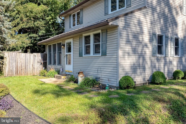 view of side of home featuring a yard