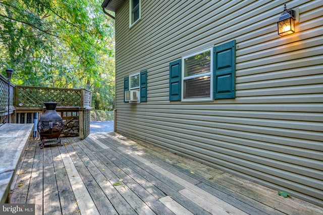 wooden deck featuring cooling unit