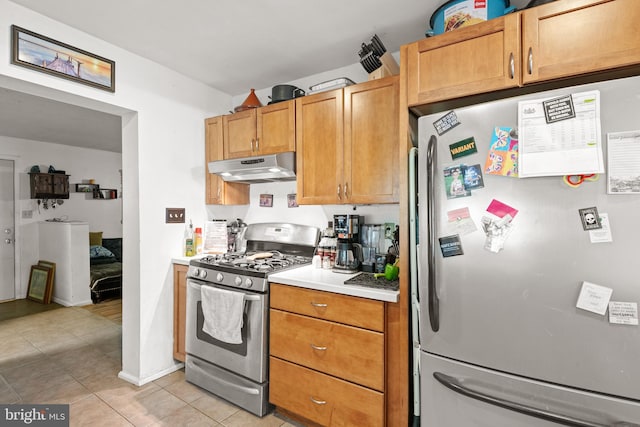 kitchen featuring light tile patterned flooring and appliances with stainless steel finishes