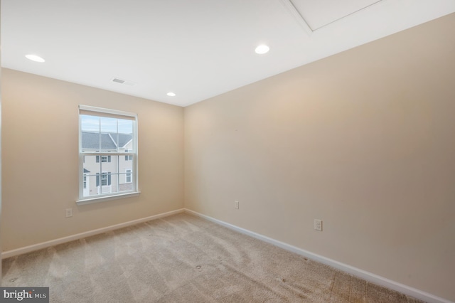 spare room with light colored carpet