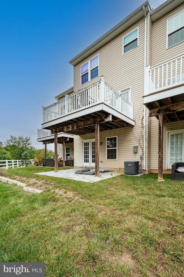 back of house with a deck, a yard, a patio, and central air condition unit