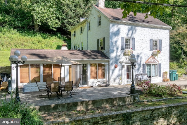 back of house with a patio