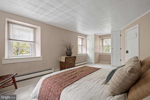 bedroom with a baseboard radiator, crown molding, and light colored carpet