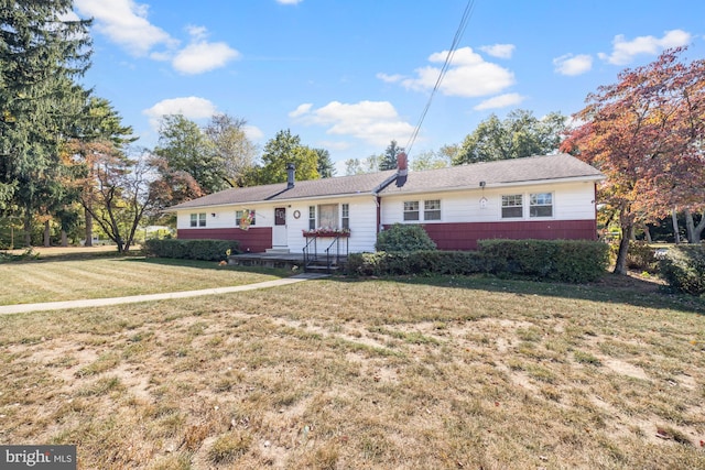 ranch-style home with a front lawn