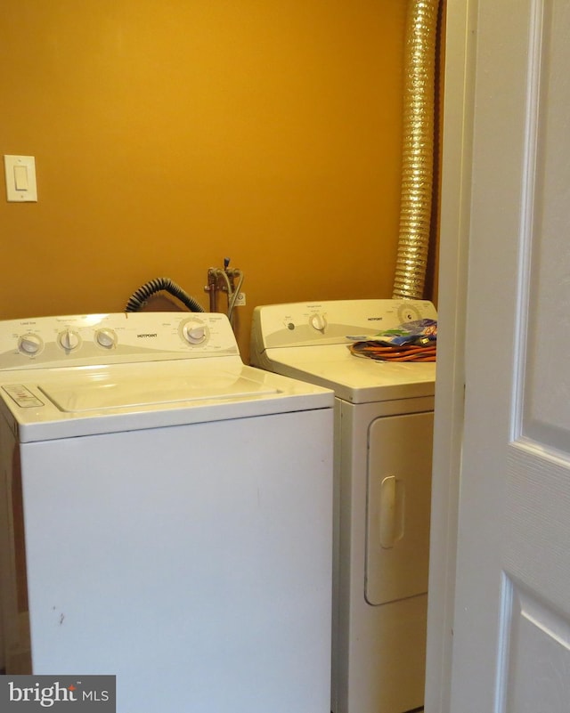 clothes washing area featuring washer and clothes dryer