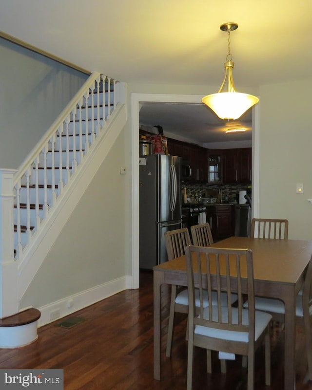 dining area with dark hardwood / wood-style floors