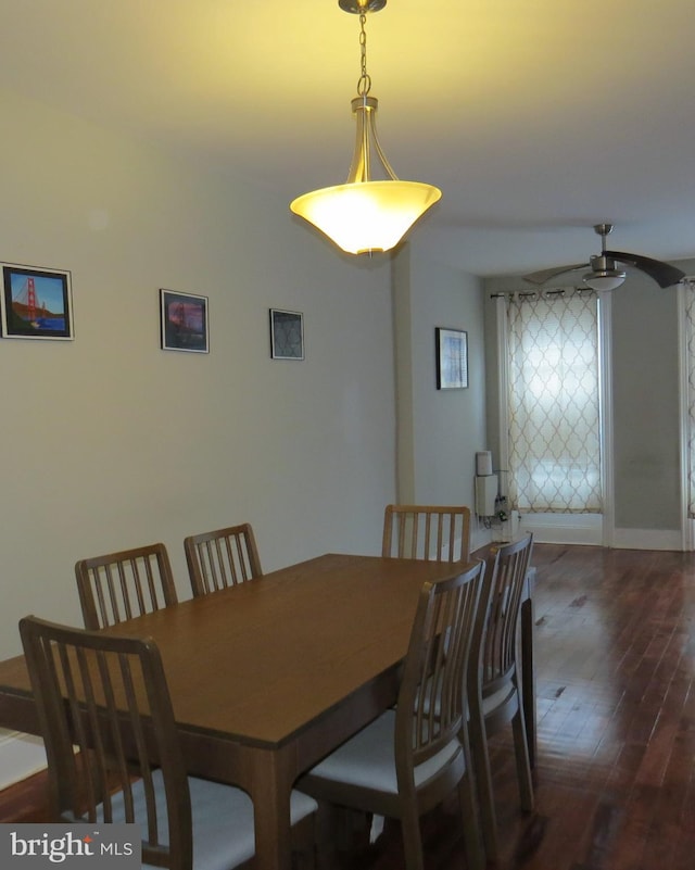 dining room with ceiling fan and dark hardwood / wood-style floors