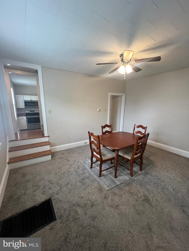 dining space with carpet and ceiling fan