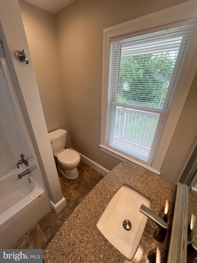 bathroom with sink, a bathing tub, tile patterned flooring, and toilet