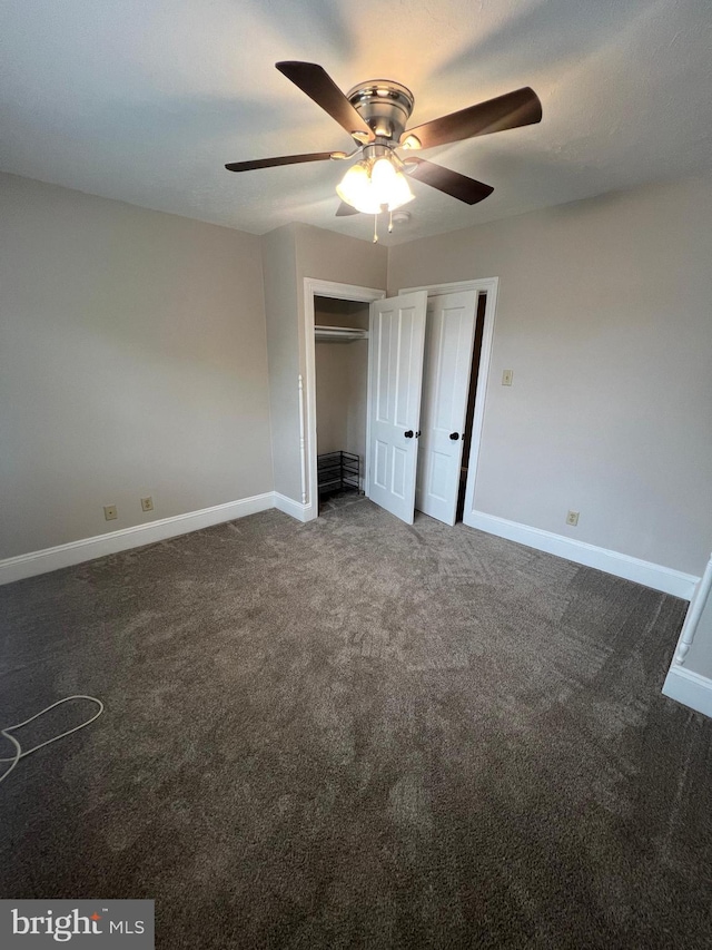 unfurnished bedroom featuring dark carpet and ceiling fan