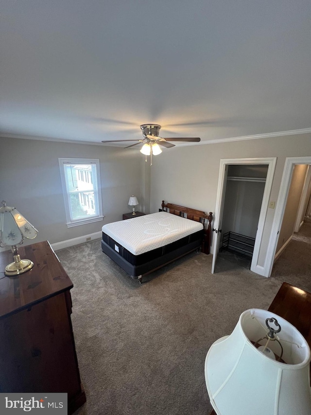 bedroom with crown molding, dark colored carpet, and ceiling fan