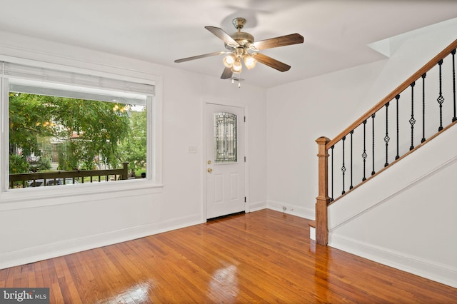 entryway with wood-type flooring and ceiling fan