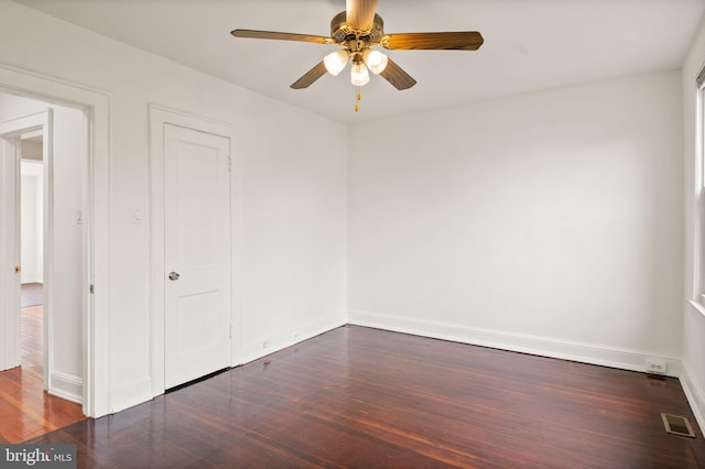 unfurnished room with dark hardwood / wood-style floors and ceiling fan