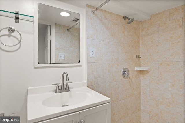 bathroom featuring vanity and a tile shower