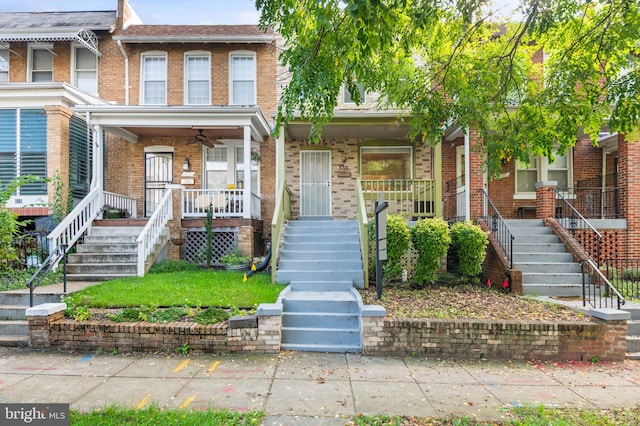 multi unit property featuring ceiling fan and a porch