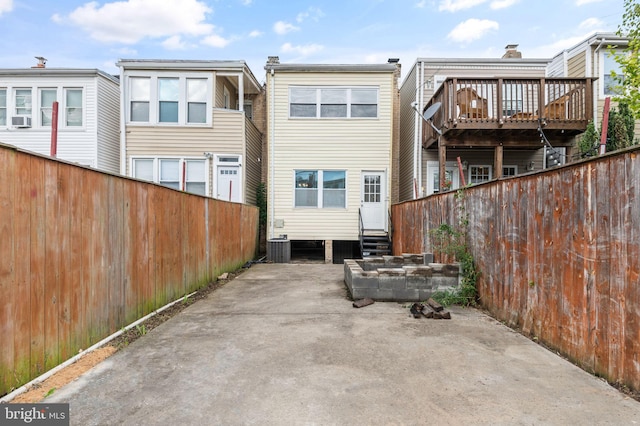 back of house with cooling unit, a deck, central AC unit, and a patio area