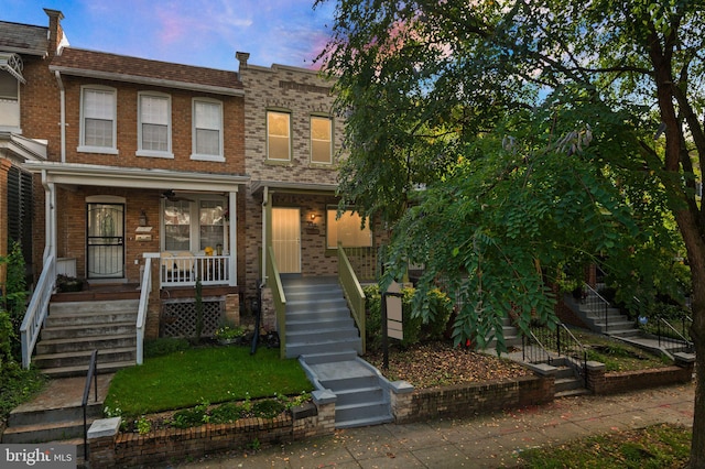 view of property featuring a yard and a porch