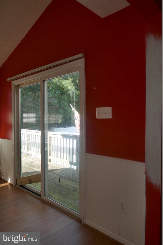 entryway featuring vaulted ceiling, hardwood / wood-style floors, and a wealth of natural light