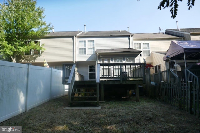 rear view of house featuring a deck