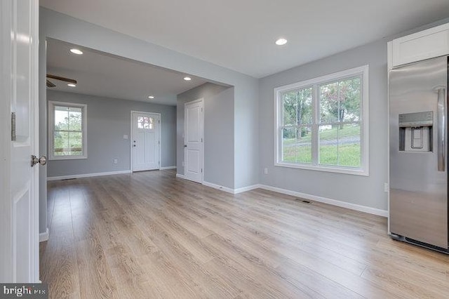 interior space with light hardwood / wood-style floors and ceiling fan