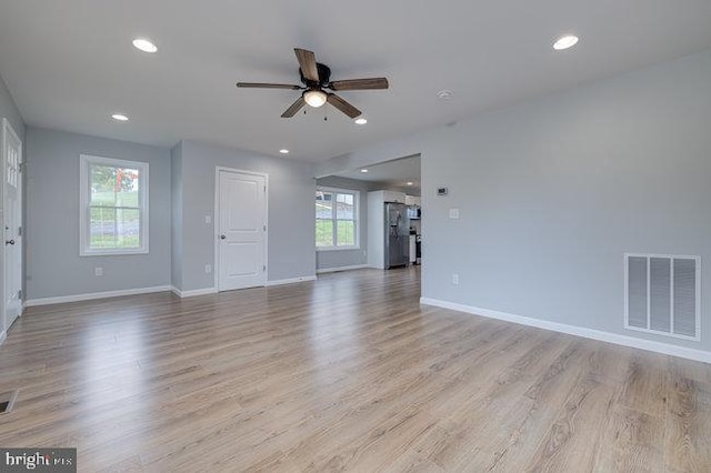 unfurnished living room featuring ceiling fan, light hardwood / wood-style flooring, and plenty of natural light