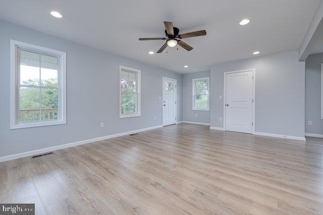 unfurnished living room with ceiling fan, light hardwood / wood-style floors, and a wealth of natural light