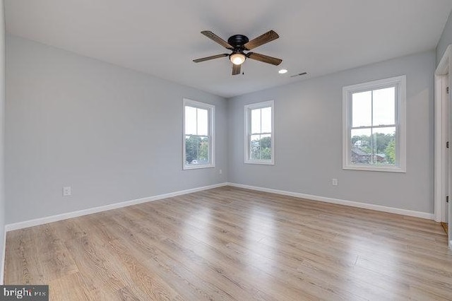 spare room with ceiling fan and light wood-type flooring