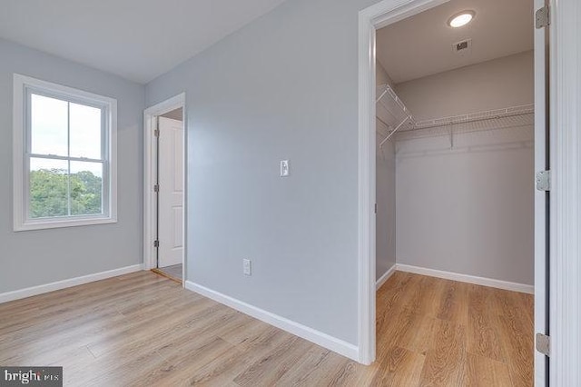 spacious closet featuring light wood-type flooring