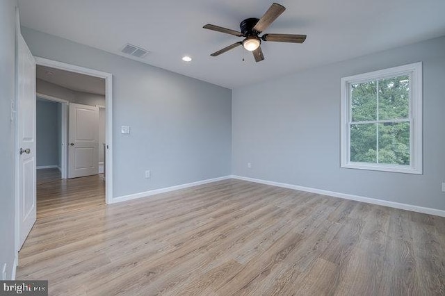 unfurnished room with ceiling fan and light wood-type flooring