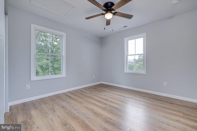 spare room with ceiling fan and light wood-type flooring