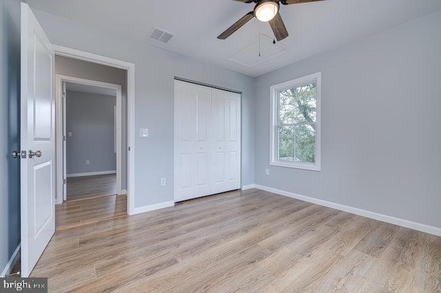 unfurnished bedroom with a closet, light hardwood / wood-style floors, and ceiling fan