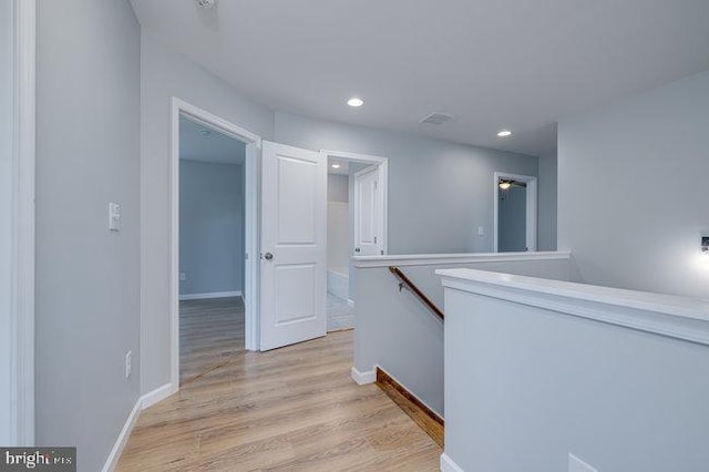 hallway with light hardwood / wood-style flooring