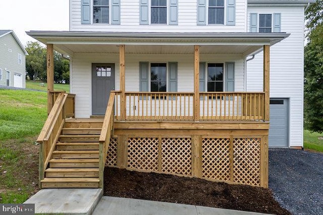 view of front of property featuring a garage and a porch