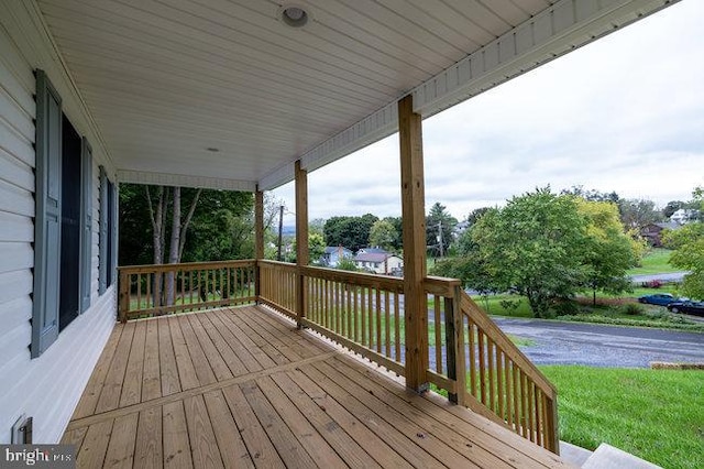 wooden terrace featuring covered porch