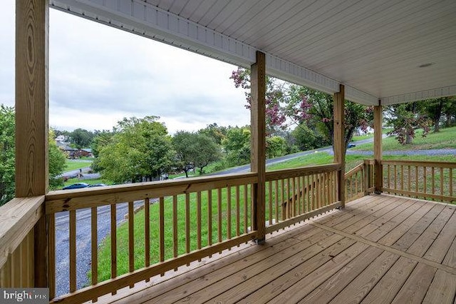 wooden deck with a lawn