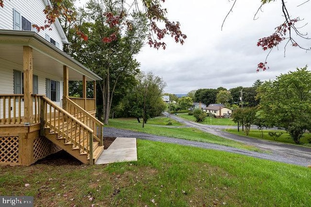 view of yard with covered porch