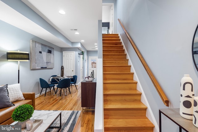 stairway with hardwood / wood-style flooring