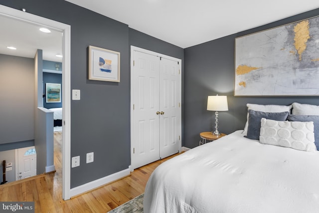 bedroom with a closet and hardwood / wood-style floors