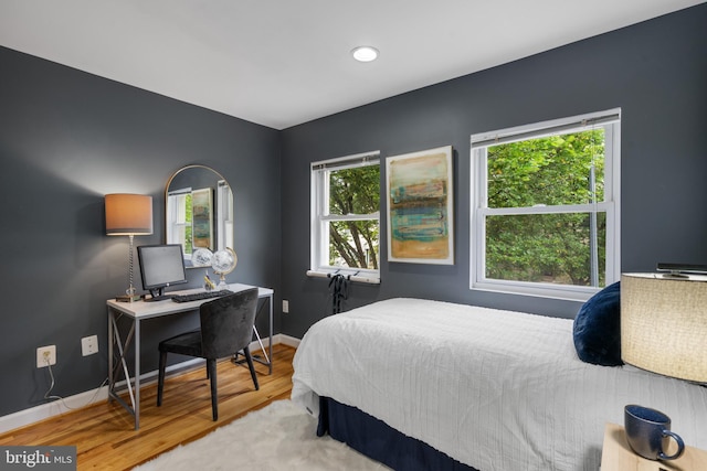 bedroom featuring light wood-type flooring and multiple windows