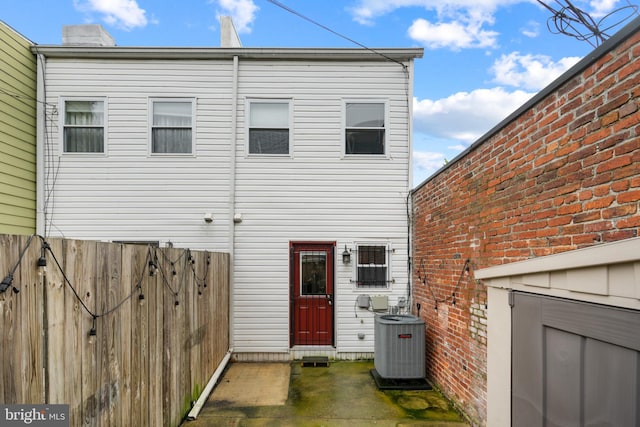 rear view of house featuring central air condition unit