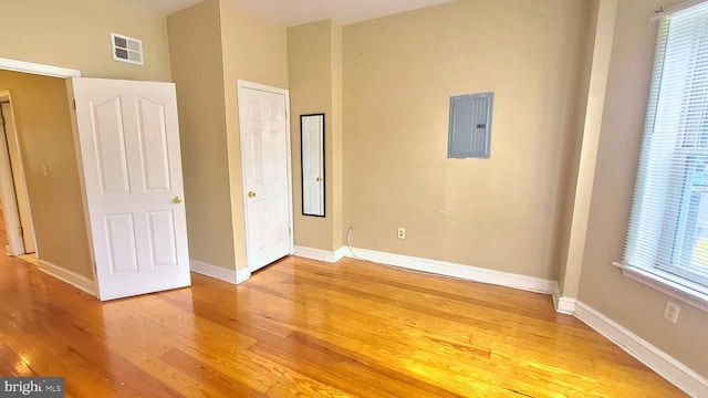 unfurnished bedroom featuring wood-type flooring and electric panel